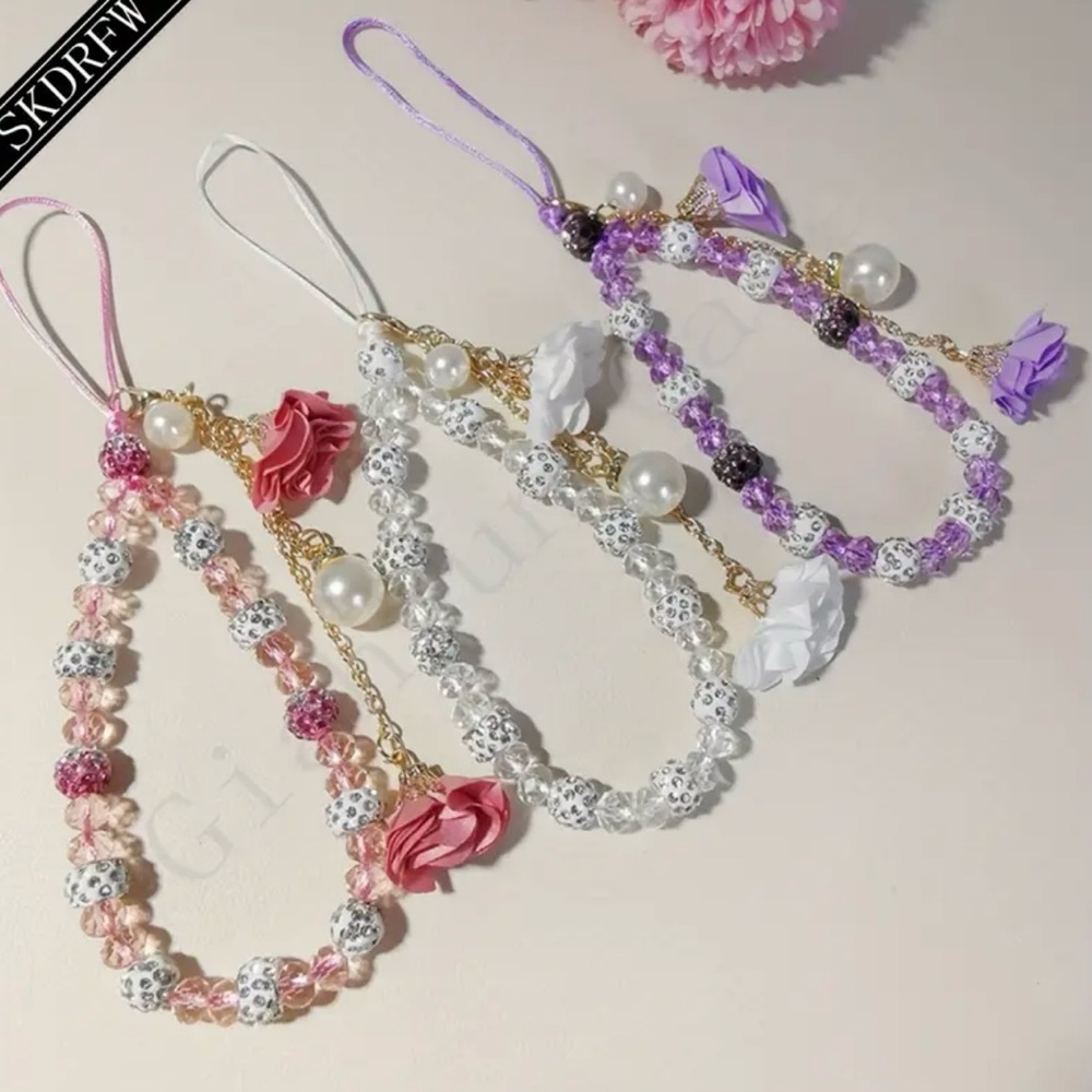 White crystal phone charm and butterfly phone grip .